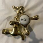 Polished brass bib taps.